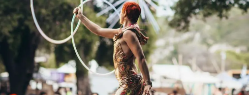 Picture taken from behind one of LED hula hoopers for events performing onstage at outdoor festival | Altus Entertainment